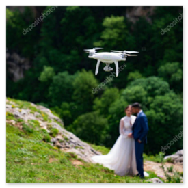 Couple filmed by drone with mountains and SLK